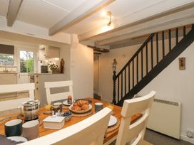 A dining room with a table and chairs at Driftwood Cottage Helston