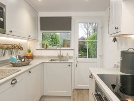 A kitchen with a sink and window at Driftwood Cottage Helston