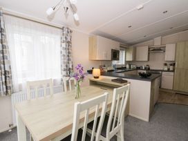 A kitchen with a table and chairs at Beechwood Lodge