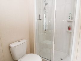 A bathroom with a shower and toilet at Beechwood Lodge 