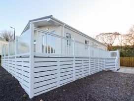 A mobile home with deck and steps at Beechwood Lodge 