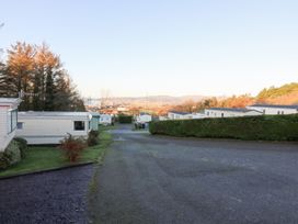 A view of caravans along a road with trees and hills at Beechwood Lodge in 