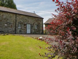 A stone building with windows and a door at Shearers in Llandysul