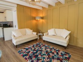 A living room with sofas and a lamp at Shearers in Llandysul