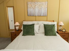 A bedroom with a bed and bedside tables at Shearers in Llandysul
