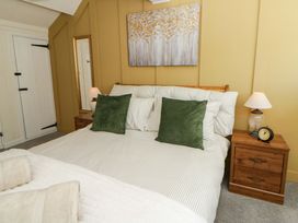 A bedroom with a bed and bedside tables at Shearers in Llandysul