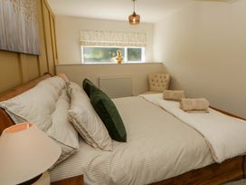 A bedroom with a bed and window at Shearers in Llandysul