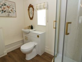 A bathroom with a sink, toilet, and shower at Shearers in Llandysul