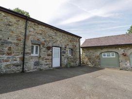 An outdoor area with stone walls and doors at Shearers in Llandysul