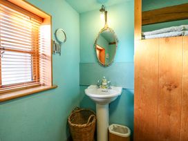 A bathroom with a sink and mirror at The Old Cow Shed in 