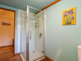 A bathroom with a shower and toilet at The Old Cow Shed in 