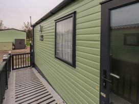 A caravan exterior with a deck and railing at Caravan