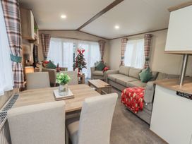 A living room with a sofa and dining area at Caravan