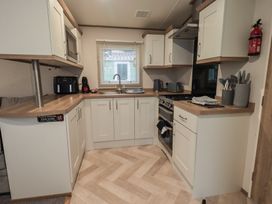 A kitchen with a sink, countertop, and various appliances at Caravan