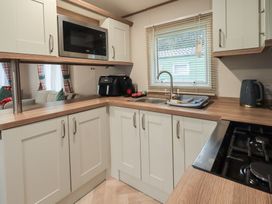A kitchen with a sink and microwave at Caravan
