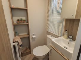 A bathroom with a toilet and sink at Caravan
