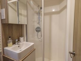 A shower and sink area in a bathroom at Caravan