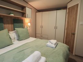A bedroom with a bed and wardrobe at Caravan
