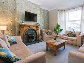 A living room with a coffee table and sofas at Canning Lodge in Colwyn Bay