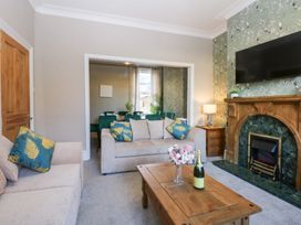 A living room with a sofa and coffee table at Canning Lodge in Colwyn Bay