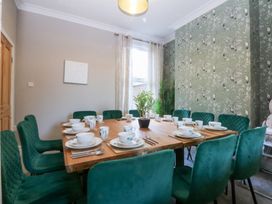 A dining room with a table set for meals at Canning Lodge Colwyn Bay