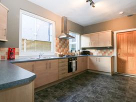 A kitchen with cabinets and a stove at Canning Lodge in Colwyn Bay