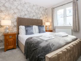 A bedroom with a bed and bedside table at Canning Lodge in Colwyn Bay