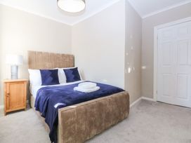A bedroom with a bed and bedside table at Canning Lodge in Colwyn Bay