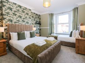 A bedroom with two beds at Canning Lodge in Colwyn Bay