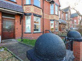 A house entrance with a front door and windows at Canning Lodge in Colwyn Bay