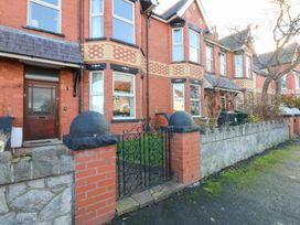 A house with a front door and garden at Canning Lodge in Colwyn Bay