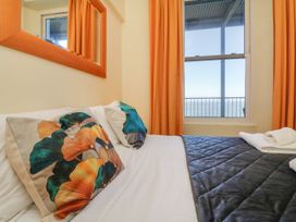 A bedroom with a bed and pillows at Val's Seaview in Ilfracombe