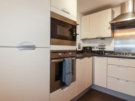 A kitchen with appliances and cabinetry at 18 Pagoda Drive in St. Austell