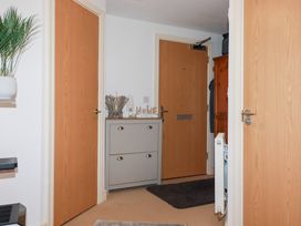 A hallway with a cabinet and doors at 18 Pagoda Drive St. Austell