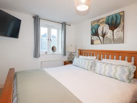 A bedroom with a bed and television at 18 Pagoda Drive St. Austell