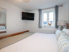 A bedroom with a bed and television at 18 Pagoda Drive St. Austell