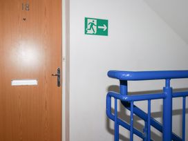 A door with number 18 and an exit sign near a staircase at 18 Pagoda Drive St. Austell
