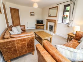 A living room with sofas and a coffee table at The Coach House in Carnforth