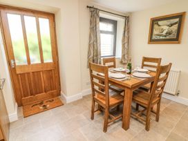 A dining room with a table and chairs at The Coach House in Carnforth