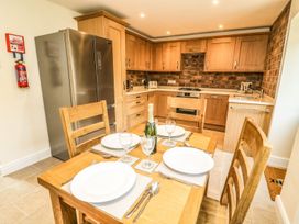 A dining table with chairs in the kitchen at The Coach House in Carnforth