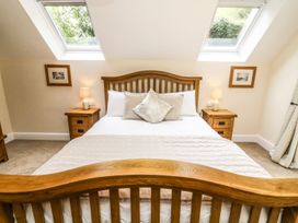 A bedroom with a bed and bedside tables at The Coach House in Carnforth