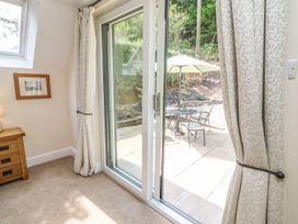A living room with a view of a patio at The Coach House in Carnforth