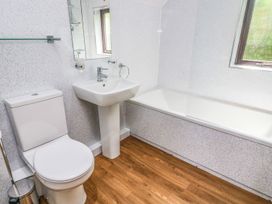 A bathroom with a sink, toilet, and bathtub at The Coach House in Carnforth