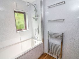 A bathroom with a shower and bathtub at The Coach House in Carnforth