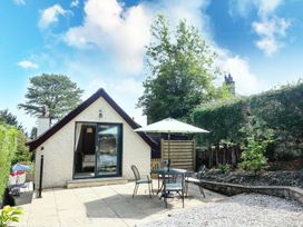 A house with patio furniture in a garden at The Coach House in Carnforth