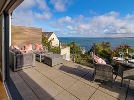 A balcony with outdoor seating and a sea view at 2 Remera in St. Ives