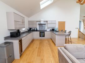 A kitchen with modern appliances and countertop at 2 Remera in St. Ives
