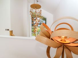 A chandelier and window in a hallway at 2 Remera St. Ives