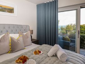 A bedroom with a bed and pastries at 2 Remera in St. Ives