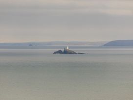 A lighthouse on an island in the ocean at 2 Remera St. Ives